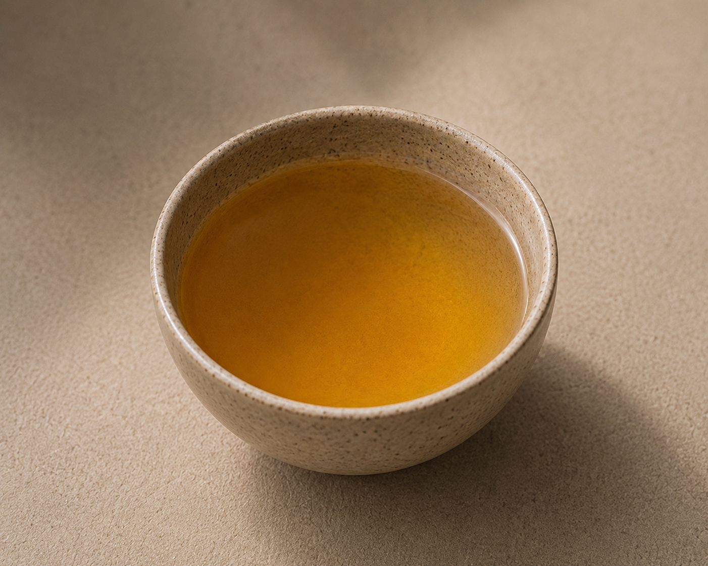 Freshly brewed Tie Guan Yin oolong tea in a ceramic cup