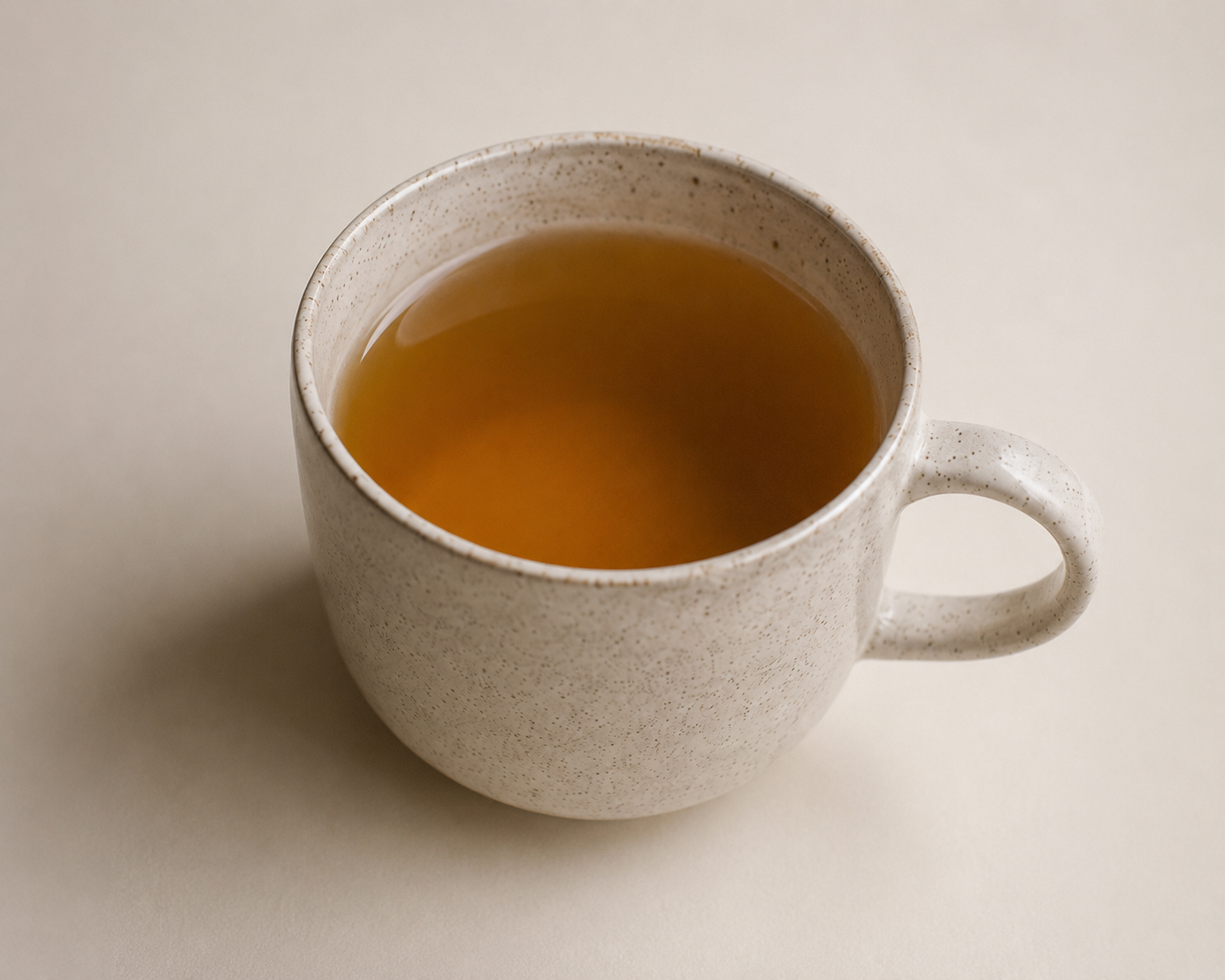 Freshly brewed Botanical Sunset herbal tea in a ceramic cup